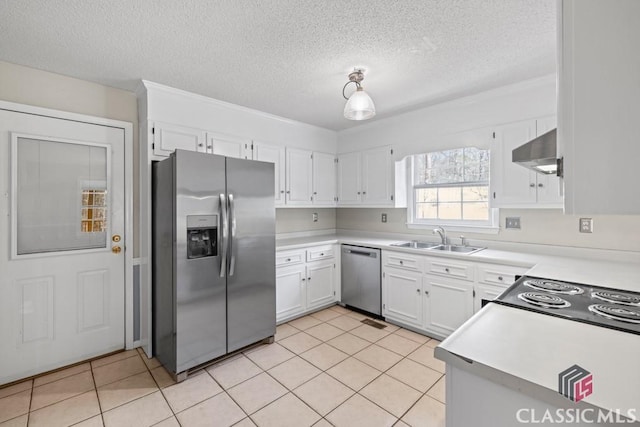 kitchen with white cabinets, appliances with stainless steel finishes, light countertops, a sink, and exhaust hood