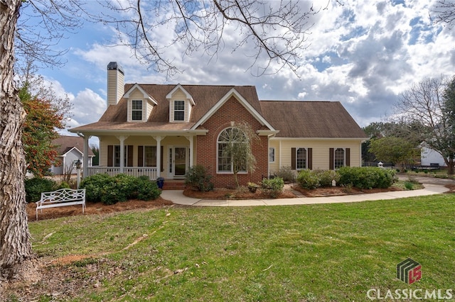 cape cod home with covered porch, brick siding, a front lawn, and a chimney