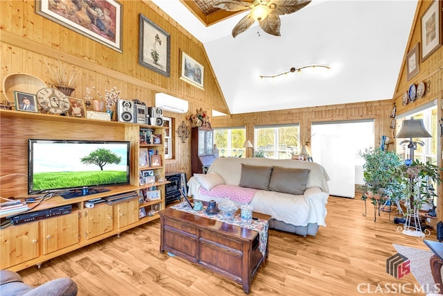 living area with high vaulted ceiling, light wood-style flooring, wooden walls, and a wall mounted AC