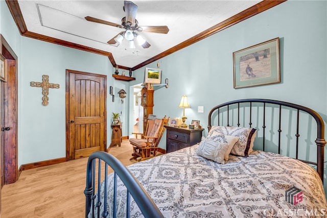 bedroom with ornamental molding, ceiling fan, baseboards, and wood finished floors