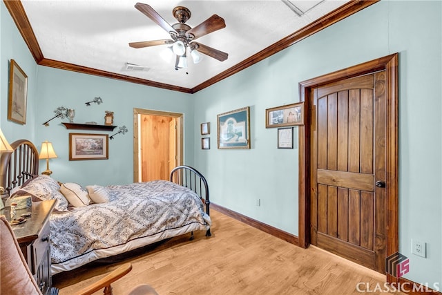 bedroom featuring crown molding, visible vents, light wood-style flooring, a ceiling fan, and baseboards