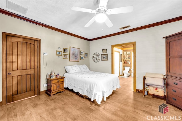 bedroom featuring light wood-type flooring, visible vents, crown molding, and baseboards