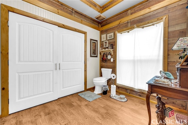 bathroom with toilet and wood finished floors