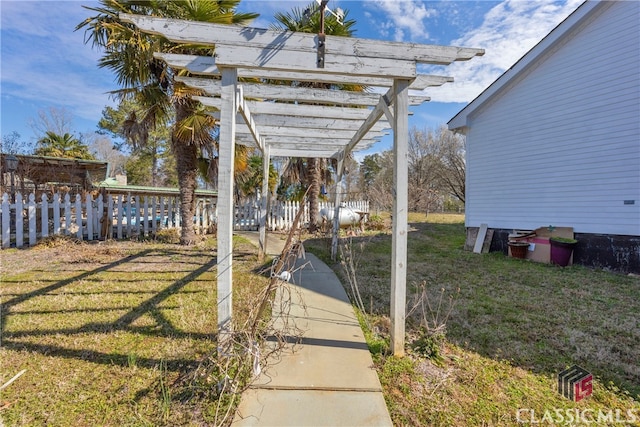 view of yard featuring fence and a pergola