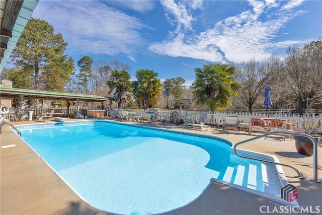 view of swimming pool featuring fence, a diving board, a fenced in pool, and a patio