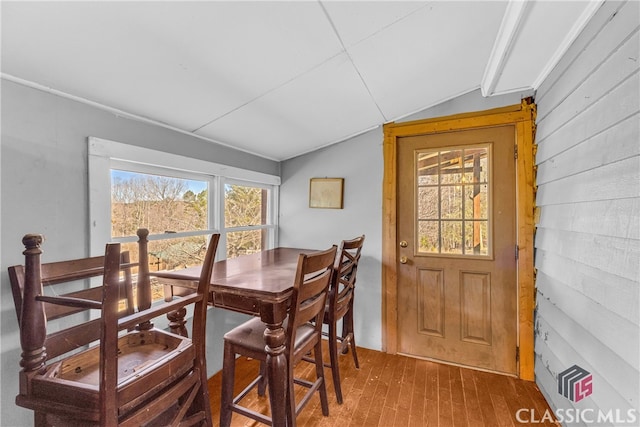 dining room featuring lofted ceiling and wood finished floors