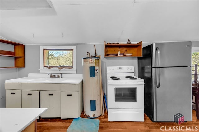 kitchen with electric water heater, white electric range, a sink, freestanding refrigerator, and open shelves