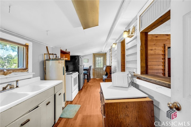 kitchen featuring white electric range oven, light countertops, vaulted ceiling, a sink, and light wood-type flooring