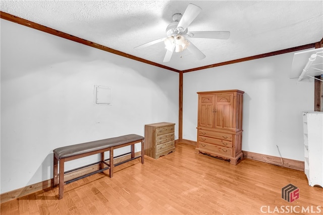 bonus room with a textured ceiling, ceiling fan, baseboards, and light wood-style floors