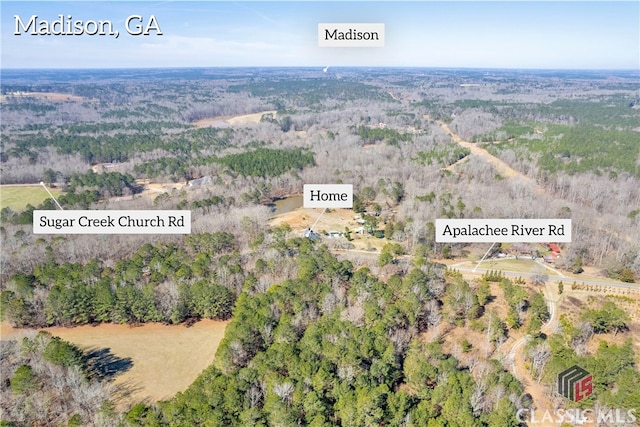 birds eye view of property with a forest view