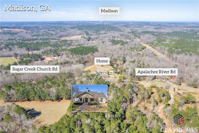 birds eye view of property with a forest view