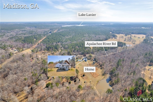 bird's eye view featuring a wooded view