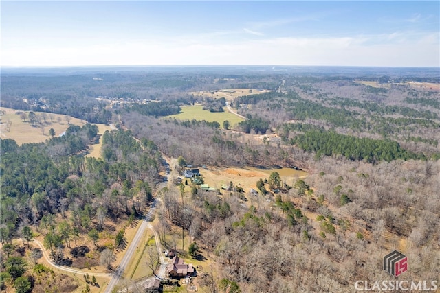 drone / aerial view featuring a view of trees