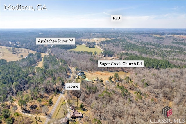 birds eye view of property featuring a wooded view