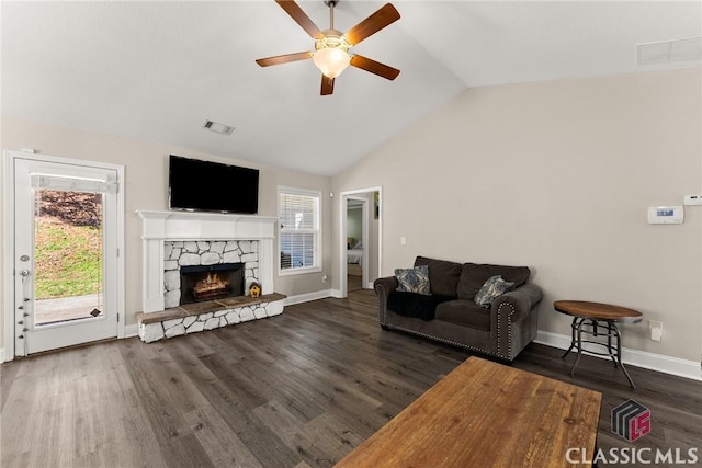 living area featuring dark wood-style floors, a fireplace, visible vents, vaulted ceiling, and baseboards