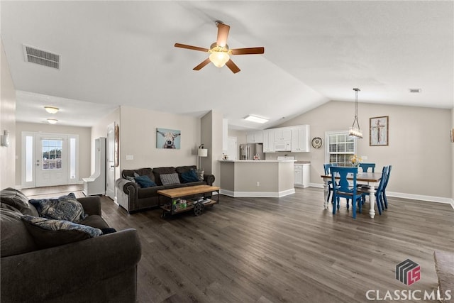 living area featuring lofted ceiling, visible vents, dark wood finished floors, and ceiling fan