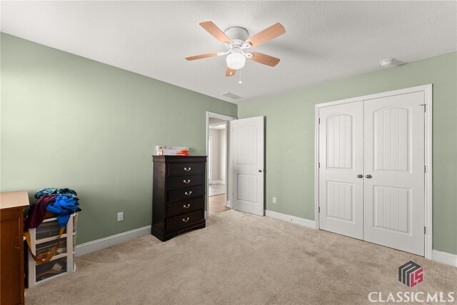 bedroom featuring carpet floors, baseboards, visible vents, and a closet