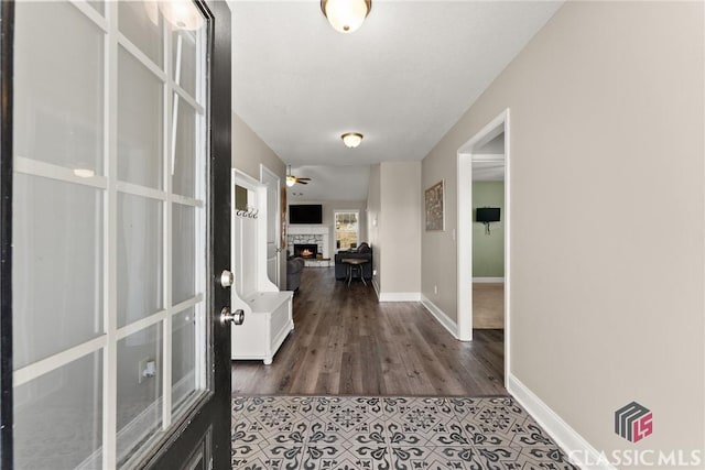 hall with french doors, baseboards, and wood finished floors