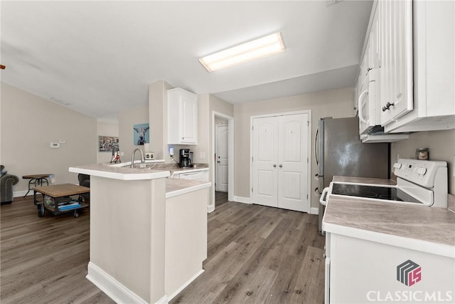 kitchen with a peninsula, light wood-style floors, white cabinets, and light countertops