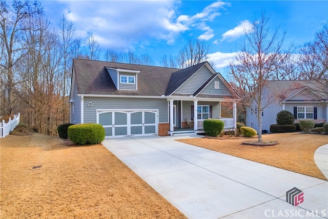 craftsman house featuring concrete driveway, an attached garage, a front yard, a porch, and brick siding