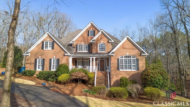 view of front of property with covered porch and brick siding