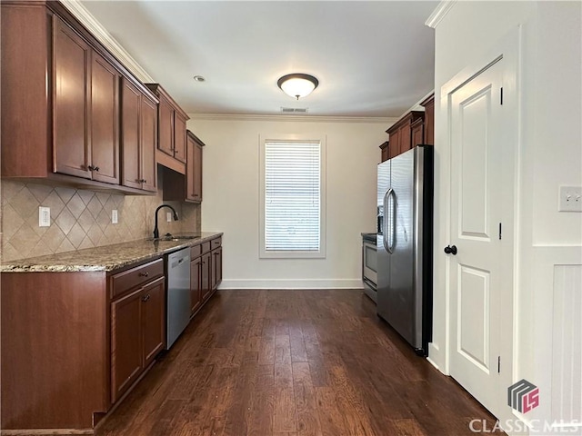 kitchen with crown molding, visible vents, appliances with stainless steel finishes, a sink, and light stone countertops