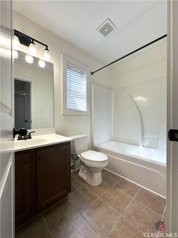 bathroom featuring shower / bathtub combination, toilet, vanity, visible vents, and tile patterned floors