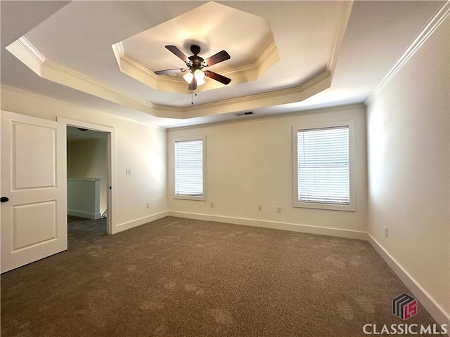 empty room featuring ceiling fan, visible vents, a raised ceiling, and dark colored carpet