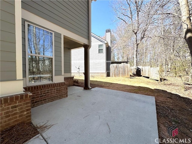 view of patio / terrace featuring fence