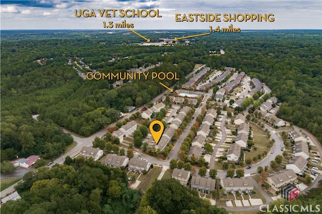 birds eye view of property featuring a residential view and a wooded view