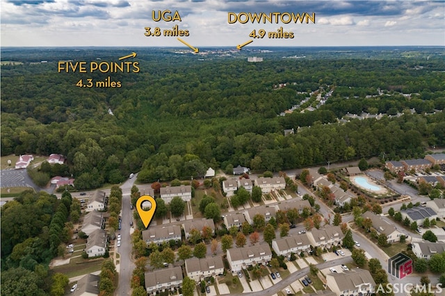 birds eye view of property with a residential view and a wooded view