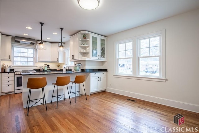 kitchen featuring white cabinets, dark countertops, and open shelves