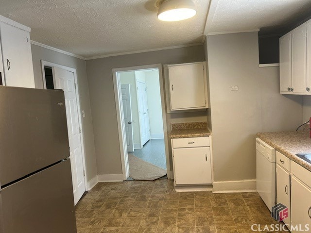 kitchen featuring white cabinets, dishwasher, ornamental molding, freestanding refrigerator, and a textured ceiling