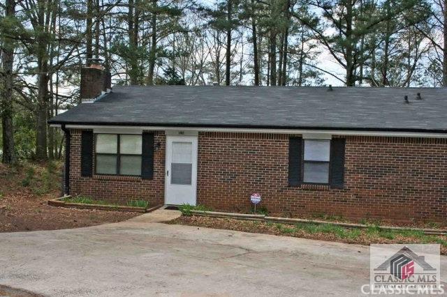 single story home with brick siding and a chimney