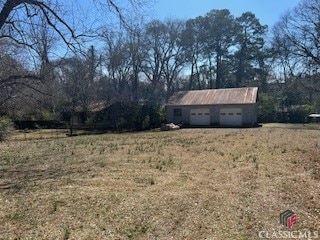 view of yard with an outbuilding and an attached garage