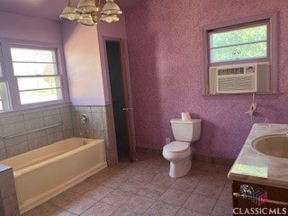 bathroom featuring double vanity, toilet, a bath, cooling unit, and a sink