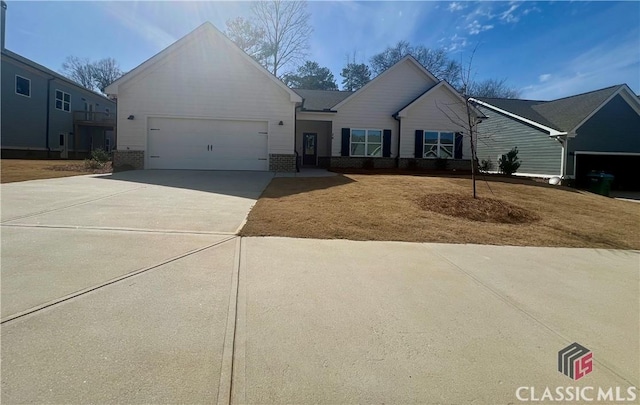 ranch-style home with a garage, brick siding, and driveway