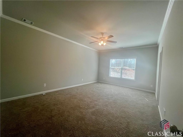 spare room with carpet, visible vents, ornamental molding, ceiling fan, and baseboards