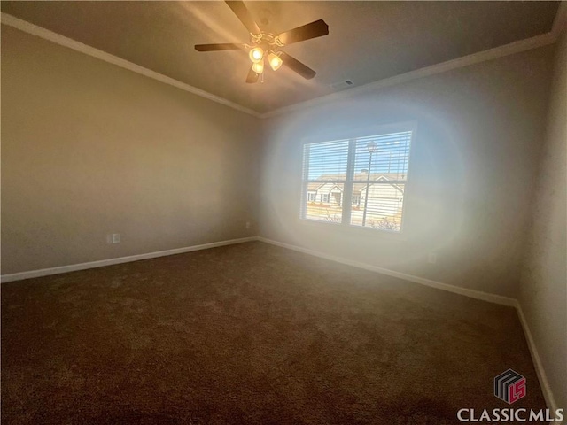 unfurnished room with carpet, visible vents, crown molding, and baseboards