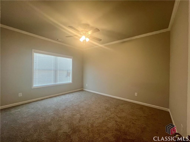 spare room featuring baseboards and crown molding