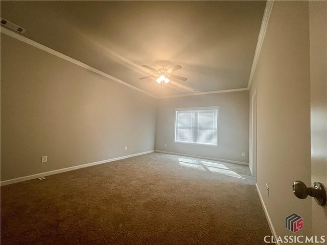 spare room with crown molding, visible vents, a ceiling fan, carpet flooring, and baseboards