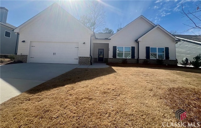 single story home with a garage, brick siding, driveway, and a front lawn