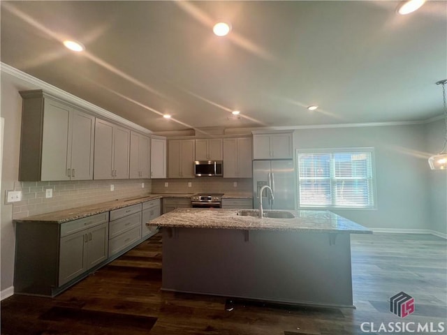 kitchen with appliances with stainless steel finishes, ornamental molding, backsplash, and light stone counters