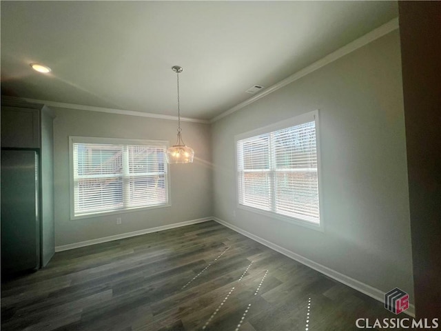 unfurnished dining area with ornamental molding, dark wood-type flooring, visible vents, and baseboards