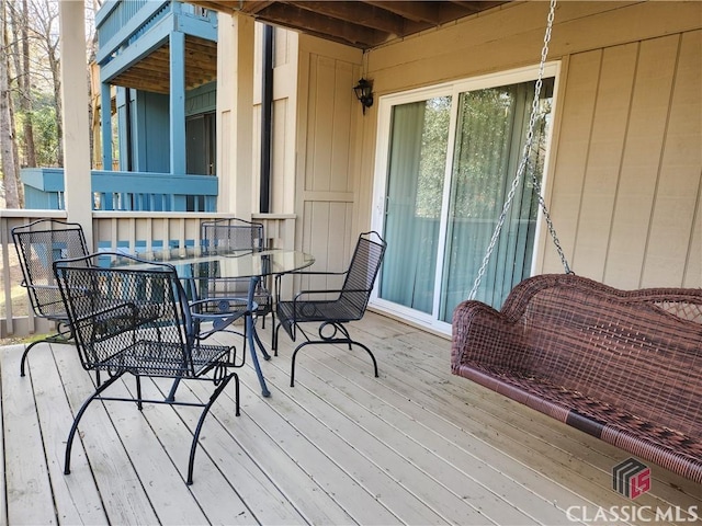 wooden deck featuring outdoor dining area