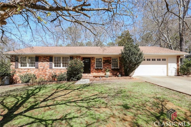 ranch-style home with a garage, a front yard, concrete driveway, and brick siding