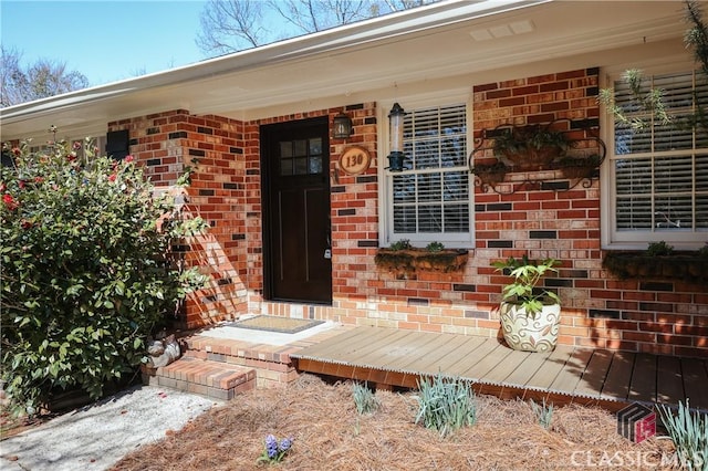 doorway to property with brick siding