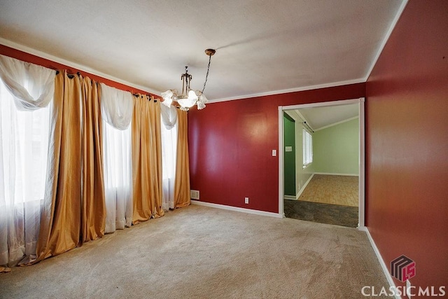 carpeted empty room featuring crown molding, baseboards, and a notable chandelier