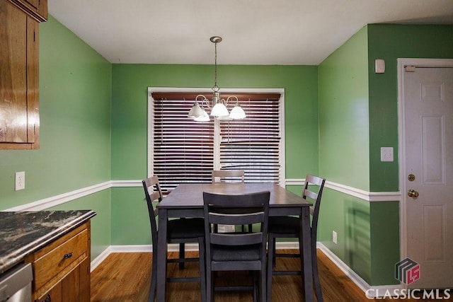 dining space with dark wood-style flooring, baseboards, and an inviting chandelier