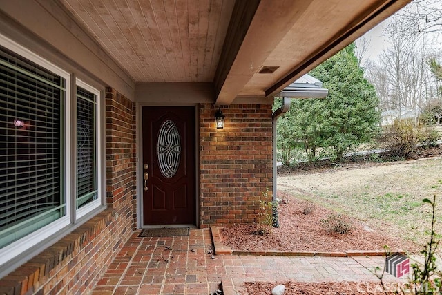 entrance to property with brick siding